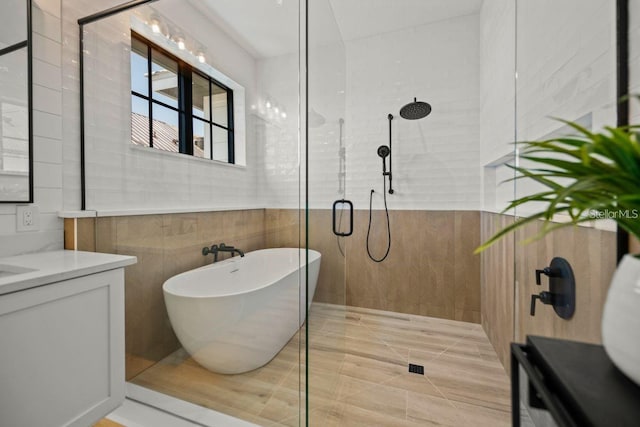 89 Avenida Messina, Sarasota, FL 34242 - bathroom featuring a freestanding tub, tile walls, vanity, and a tile shower