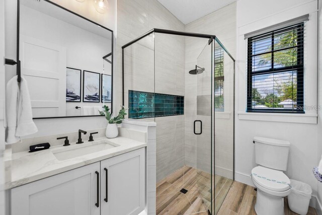 89 Avenida Messina, Sarasota, FL 34242 - bathroom with toilet, vanity, and a stall shower