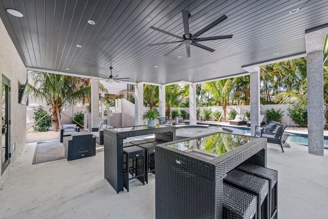 89 Avenida Messina, Sarasota, FL 34242 - view of patio with exterior bar, a ceiling fan, a fenced backyard, a fenced in pool, and an outdoor hangout area
