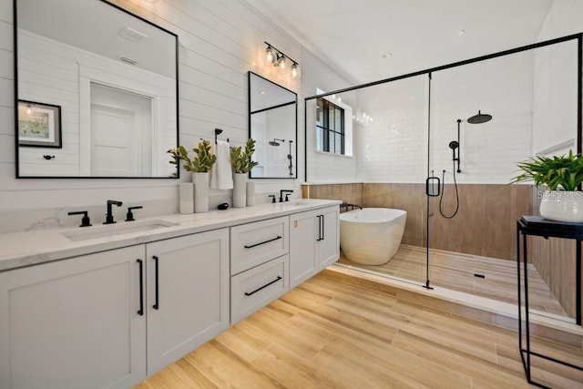 89 Avenida Messina, Sarasota, FL 34242 - full bath with wood finished floors, a sink, a stall shower, a soaking tub, and double vanity