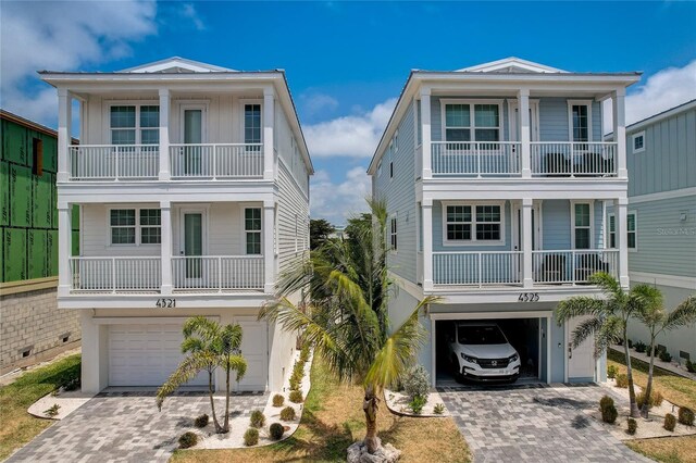 4206 Saltwater Pearl Way, Cortez, FL 34215 - beach home featuring an attached garage, decorative driveway, and a balcony