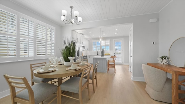 4206 Saltwater Pearl Way, Cortez, FL 34215 - dining area featuring light wood finished floors, wooden ceiling, baseboards, and a chandelier