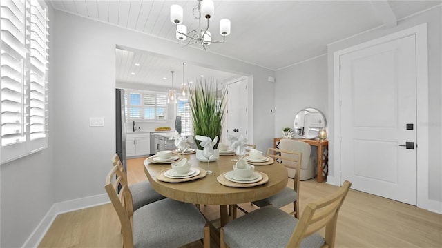 4206 Saltwater Pearl Way, Cortez, FL 34215 - dining space with light wood-style flooring, baseboards, and a chandelier