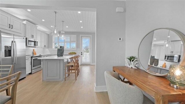 4206 Saltwater Pearl Way, Cortez, FL 34215 - kitchen with recessed lighting, stainless steel appliances, a breakfast bar, light wood-style floors, and a center island