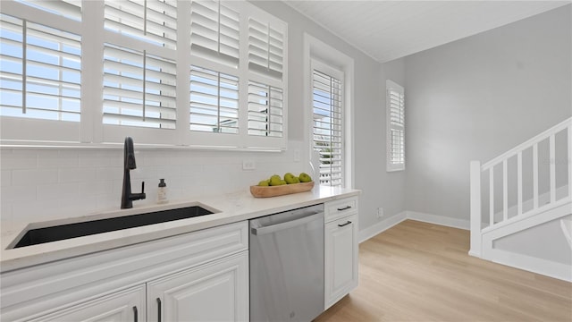4206 Saltwater Pearl Way, Cortez, FL 34215 - bar with stainless steel dishwasher, light wood-style flooring, a sink, baseboards, and backsplash