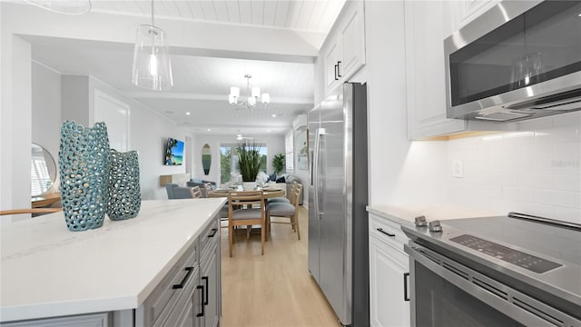 4206 Saltwater Pearl Way, Cortez, FL 34215 - kitchen featuring stainless steel appliances, tasteful backsplash, light wood-type flooring, open floor plan, and an inviting chandelier