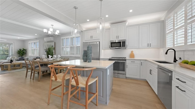 4206 Saltwater Pearl Way, Cortez, FL 34215 - kitchen featuring a sink, light wood-style floors, stainless steel appliances, backsplash, and a kitchen island
