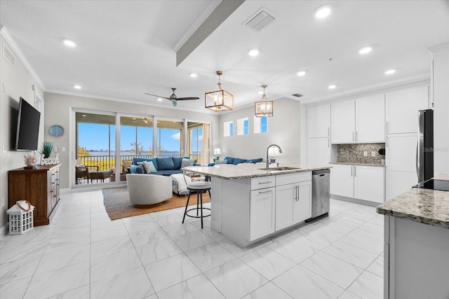 kitchen with a sink, recessed lighting, open floor plan, and dishwasher