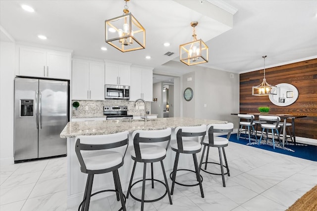 kitchen featuring marble finish floor, a chandelier, and appliances with stainless steel finishes