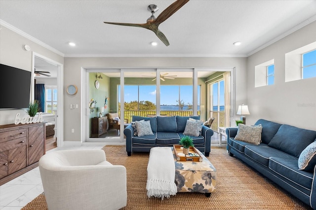 living room with ornamental molding, a ceiling fan, and a healthy amount of sunlight
