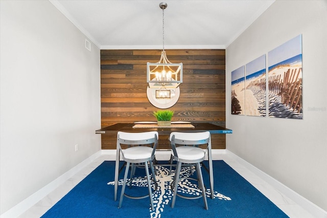 dining space with baseboards, wooden walls, a chandelier, and visible vents