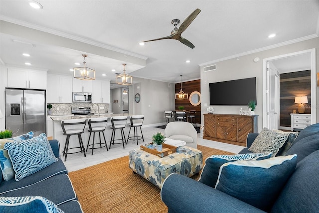 living area featuring crown molding, light tile patterned flooring, ceiling fan, and recessed lighting