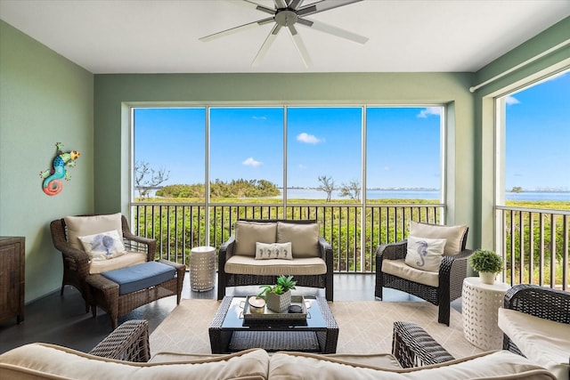 sunroom featuring a water view