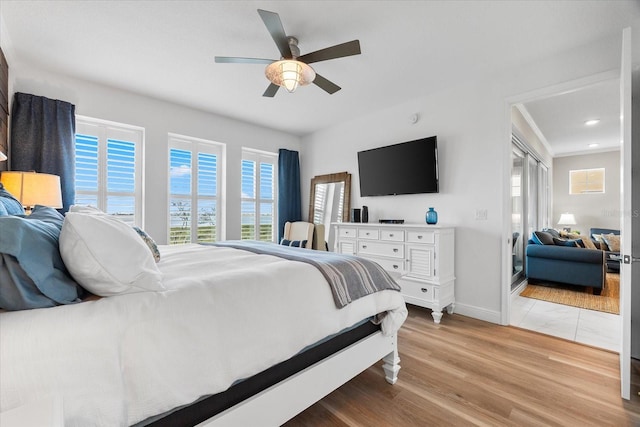 bedroom with light wood-style flooring, baseboards, a ceiling fan, and recessed lighting