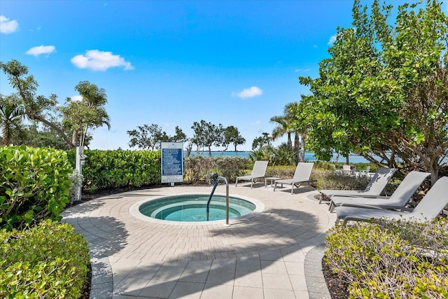 view of swimming pool with a hot tub