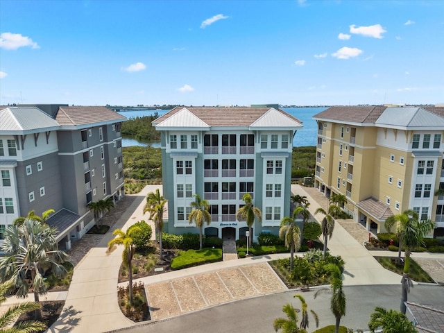 view of property with a water view and uncovered parking