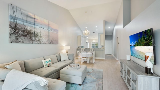 4640 Tower Hill Ln Unit 2325, Sarasota, FL 34238 - living area with light wood-style floors, high vaulted ceiling, and a notable chandelier