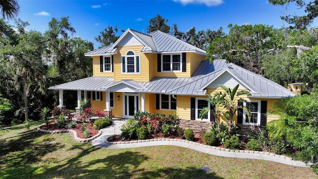 1788 Palm View Rd, Sarasota, FL 34240 - view of front of home with a porch, a standing seam roof, metal roof, and a front yard