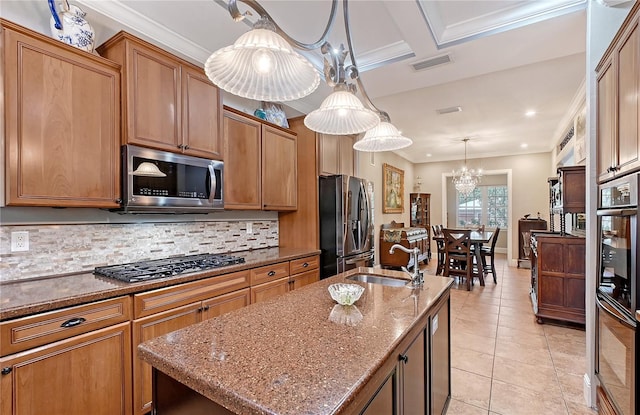 1788 Palm View Rd, Sarasota, FL 34240 - kitchen with visible vents, a center island with sink, a sink, backsplash, and stainless steel appliances