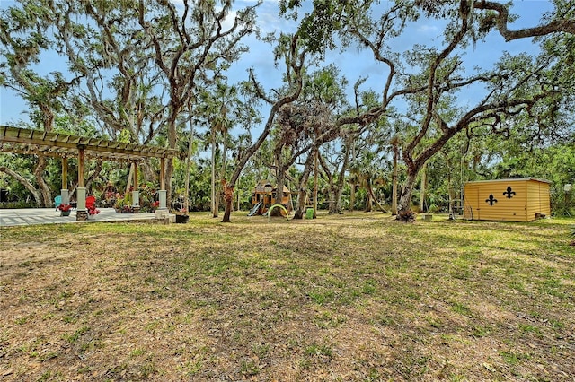 1788 Palm View Rd, Sarasota, FL 34240 - view of yard with an outdoor structure, a pergola, a playground, a patio area, and a storage shed