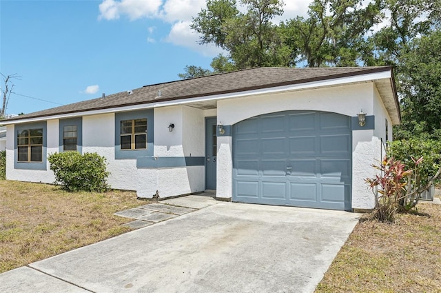 single story home featuring driveway, a front yard, a garage, a shingled roof, and stucco siding