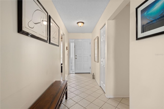 6780 Schooner Bay Cir Unit 6780, Sarasota, FL 34231 - hall with baseboards, light tile patterned flooring, and a textured ceiling