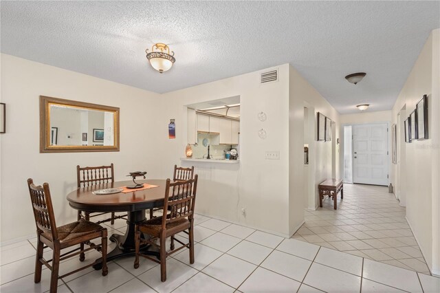 6780 Schooner Bay Cir Unit 6780, Sarasota, FL 34231 - dining space featuring light tile patterned flooring, a textured ceiling, and visible vents