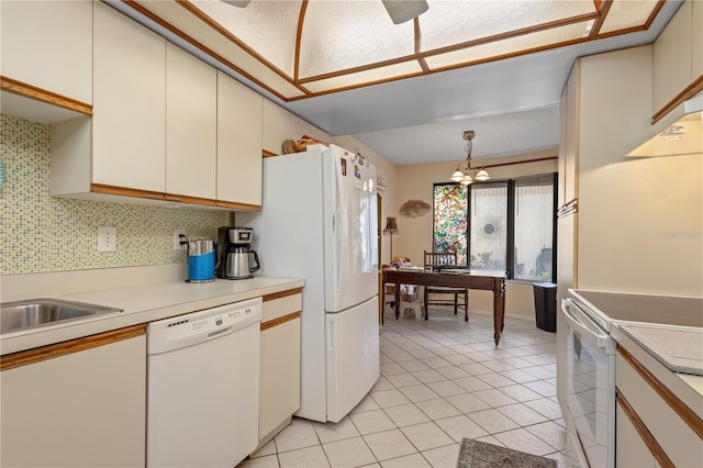 6780 Schooner Bay Cir Unit 6780, Sarasota, FL 34231 - kitchen with light tile patterned flooring, a notable chandelier, white appliances, light countertops, and hanging light fixtures