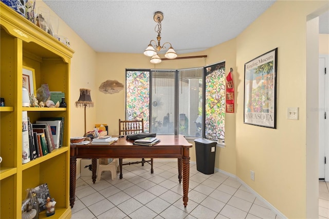 6780 Schooner Bay Cir Unit 6780, Sarasota, FL 34231 - home office featuring an inviting chandelier, a textured ceiling, and light tile patterned floors