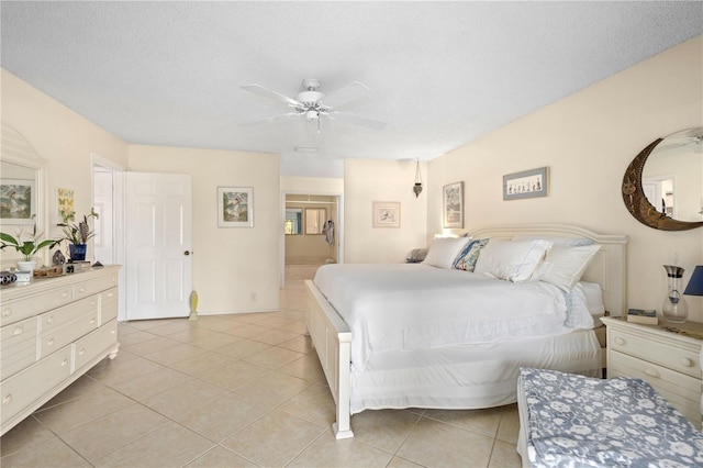 6780 Schooner Bay Cir Unit 6780, Sarasota, FL 34231 - bedroom with ceiling fan, baseboards, a textured ceiling, and light tile patterned floors