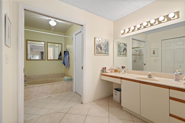 6780 Schooner Bay Cir Unit 6780, Sarasota, FL 34231 - bathroom with a garden tub, tile patterned floors, vanity, a textured ceiling, and a shower