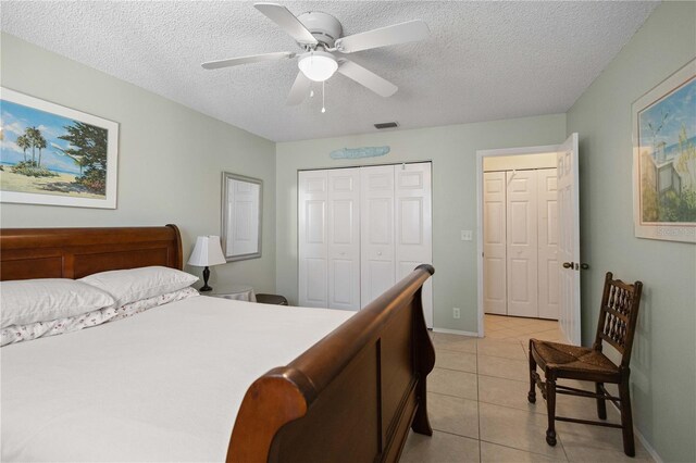 6780 Schooner Bay Cir Unit 6780, Sarasota, FL 34231 - bedroom with a closet, a textured ceiling, visible vents, and light tile patterned floors