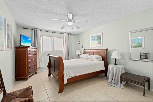 6780 Schooner Bay Cir Unit 6780, Sarasota, FL 34231 - bedroom featuring ceiling fan, a textured ceiling, and light tile patterned floors
