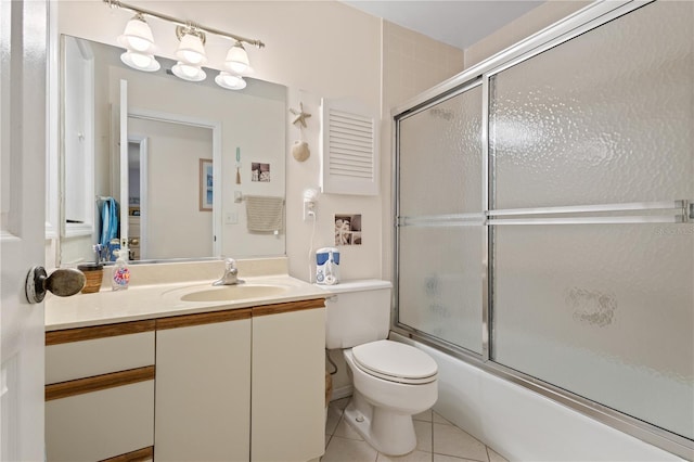 6780 Schooner Bay Cir Unit 6780, Sarasota, FL 34231 - bathroom with vanity, toilet, tile patterned flooring, and bath / shower combo with glass door