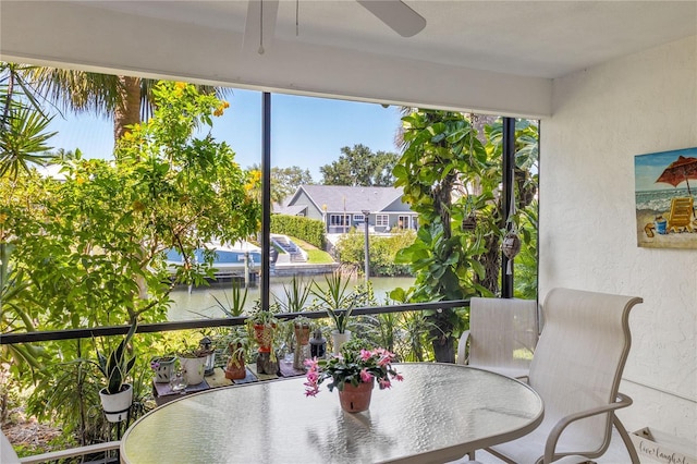 6780 Schooner Bay Cir Unit 6780, Sarasota, FL 34231 - balcony with ceiling fan, outdoor dining area, and a water view