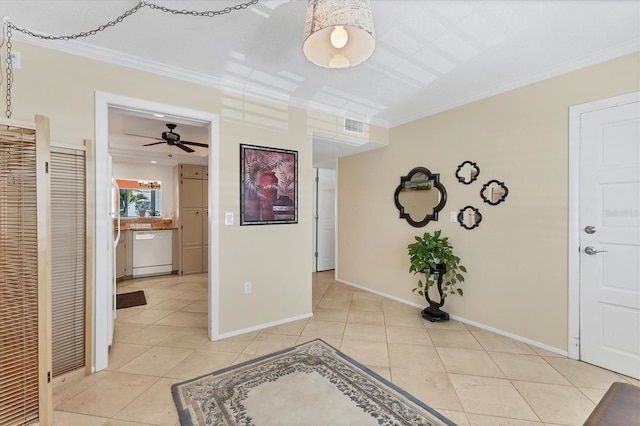 hallway featuring baseboards, ornamental molding, light tile patterned flooring, and visible vents