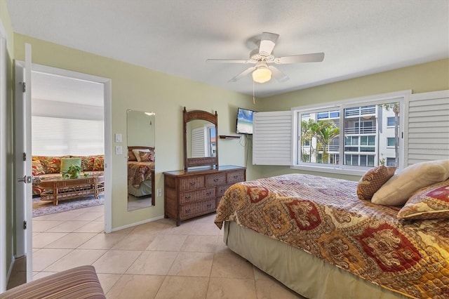 bedroom with light tile patterned floors, baseboards, and ceiling fan