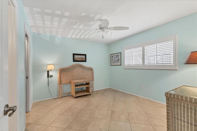 unfurnished room featuring baseboards and a ceiling fan