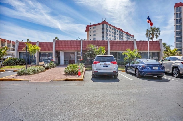 view of building exterior with uncovered parking