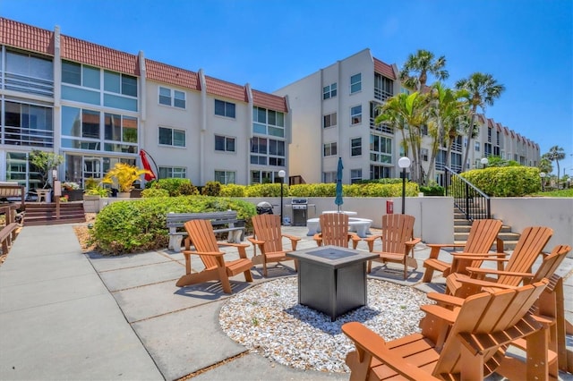 view of patio with stairs and an outdoor fire pit