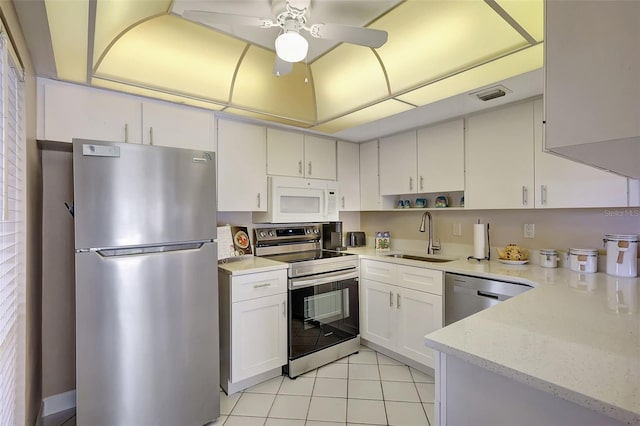845 Benjamin Franklin Dr Unit 101, Sarasota, FL 34236 - kitchen featuring stainless steel appliances, a sink, light tile patterned flooring, visible vents, and ceiling fan