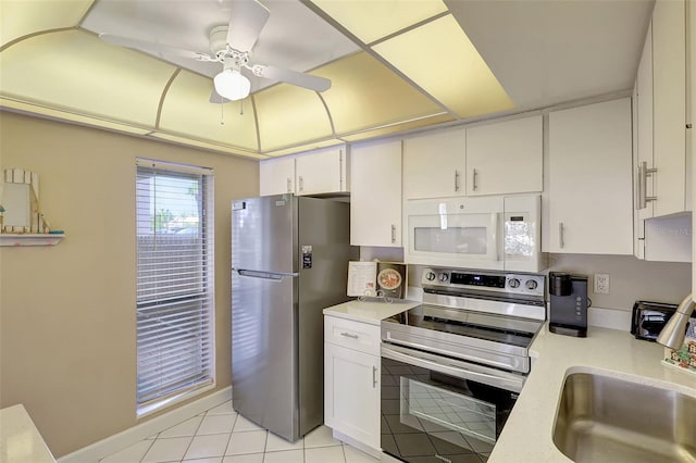 845 Benjamin Franklin Dr Unit 101, Sarasota, FL 34236 - kitchen with light countertops, a ceiling fan, a sink, appliances with stainless steel finishes, and white cabinetry