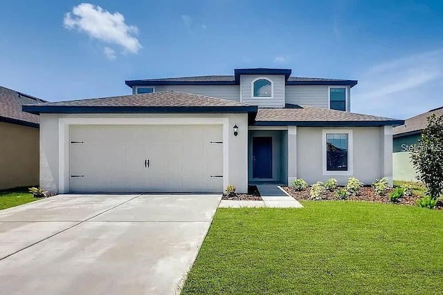 prairie-style house with driveway, a front yard, a shingled roof, and a garage