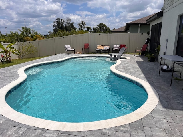 view of swimming pool featuring a patio, a fenced in pool, and a fenced backyard
