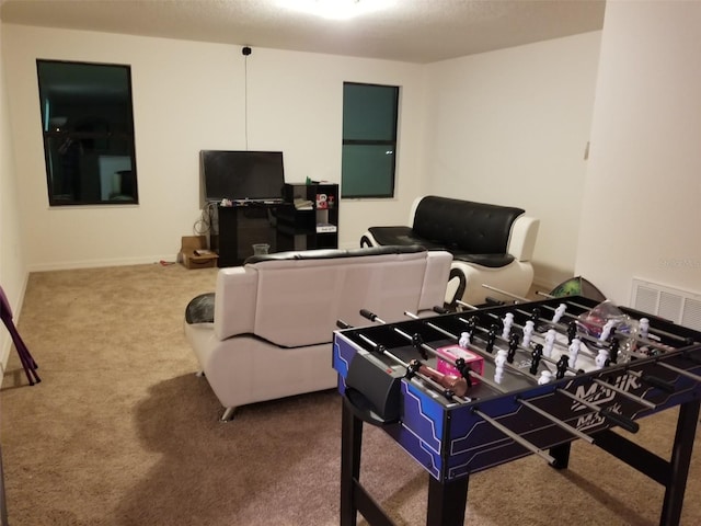 recreation room with visible vents and carpet flooring