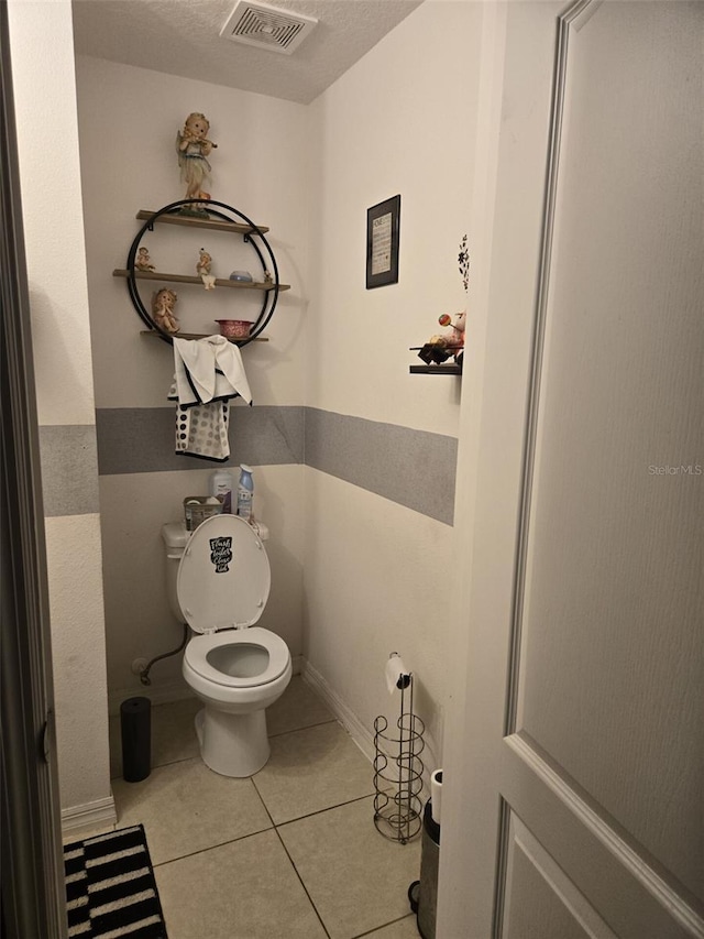 bathroom featuring tile patterned floors, visible vents, and toilet