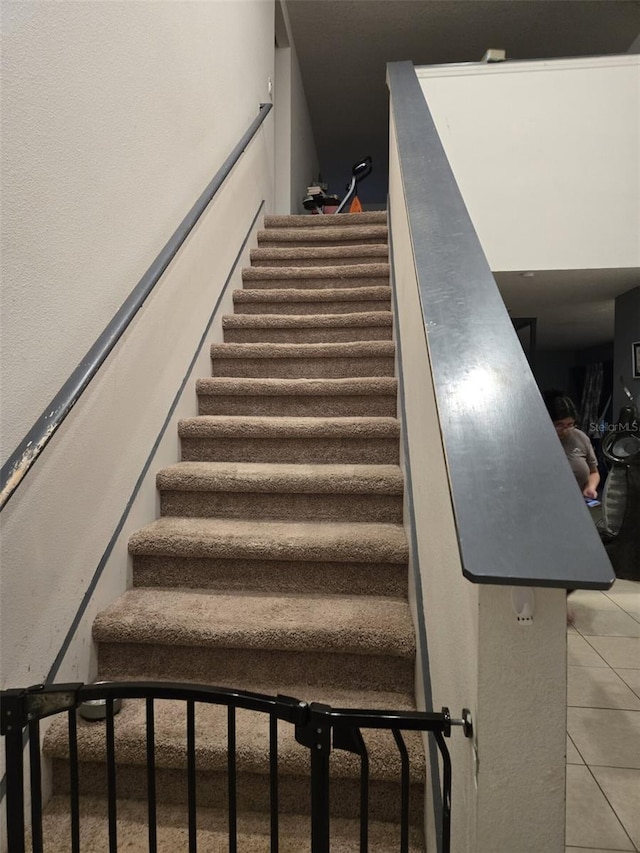 staircase with tile patterned floors