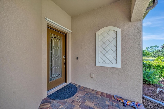 entrance to property featuring stucco siding