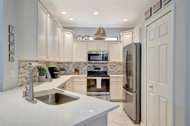 kitchen with crown molding, a sink, stainless steel appliances, light countertops, and backsplash