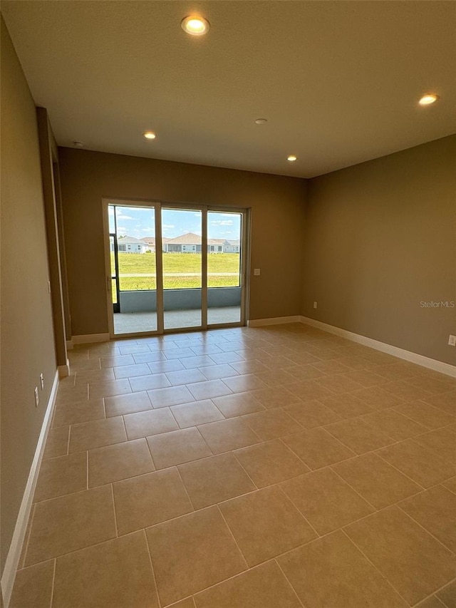 unfurnished room with baseboards, recessed lighting, and light tile patterned floors